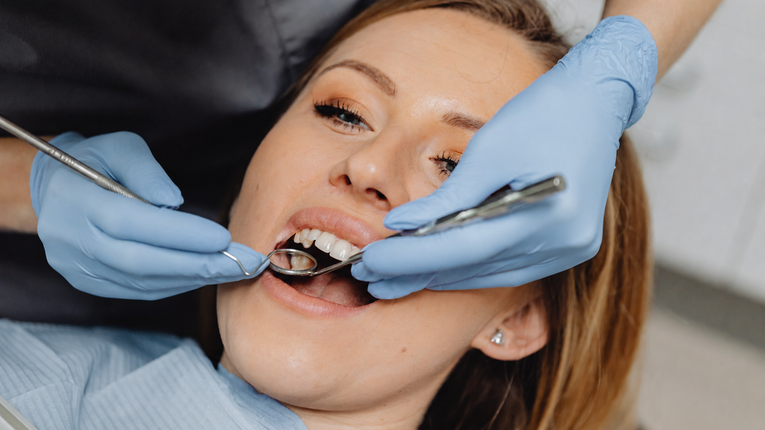 Dentist examining a patient’s molars with dental instruments before amalgam filling removal